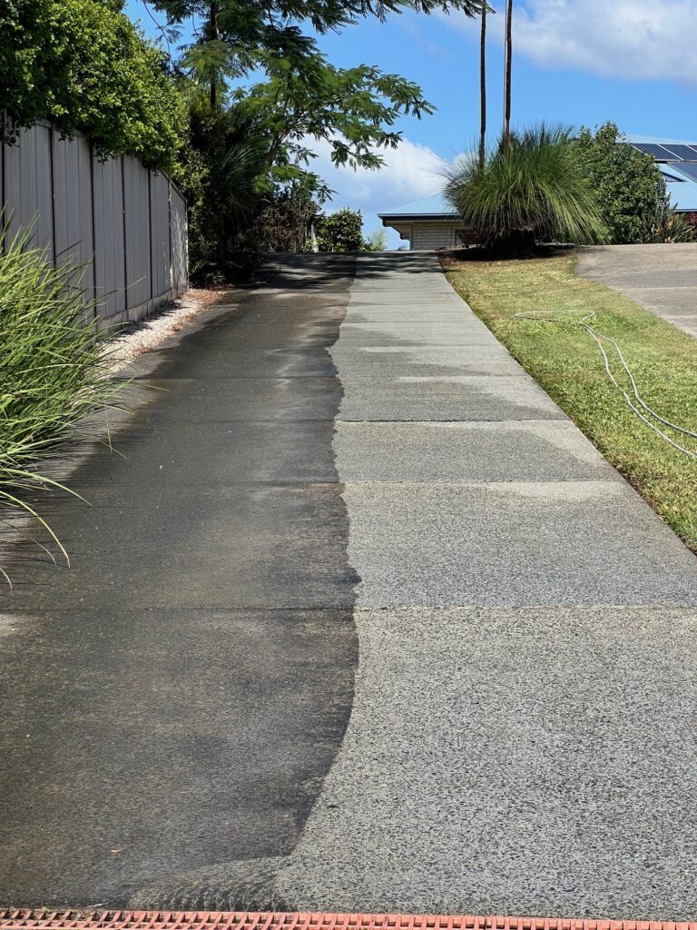 Concrete driveway after professional pressure washing by Byron Softwash